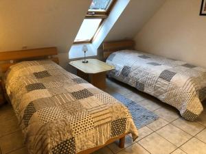 a bedroom with two beds and a window at Seestr 75 a Haus A links in Zingst