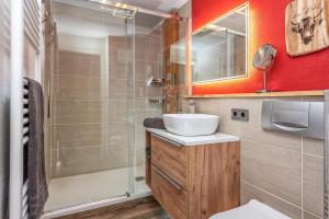 a bathroom with a sink and a shower at Alpenliebe-mit Bergblick in Oberstaufen +16 photos