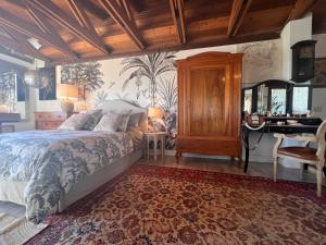 a bedroom with a bed and a desk in it at Roberta's Italian Oasi in Trevignano Romano