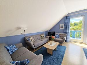 a living room with two couches and a table at _STR132b_ Haus Maren am Meer in Niendorf