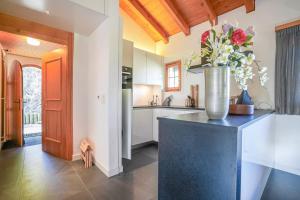 a kitchen with a vase of flowers on a counter at Chalet Quattro in Mörel