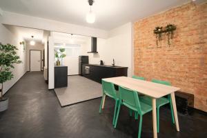 a dining room with a brick wall and a table and chairs at Two-Bedroom Apartments in the Heart of Antwerp in Antwerp