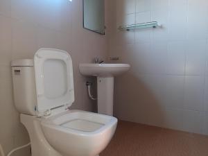 a bathroom with a white toilet and a sink at Serene Inn Kandana in Kandana