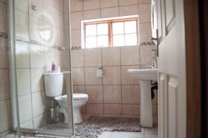 a bathroom with a toilet and a sink at Room in Guest room - Brooklyn Guesthouses in Pretoria
