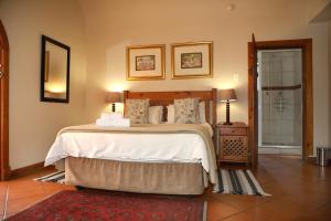 a bedroom with a large bed and a bathroom at Room in Guest room - Brooklyn Guesthouses in Pretoria