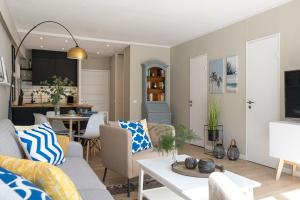 a living room with a couch and a table at Panoramic App C03-4 Sonnendeck in Sierksdorf