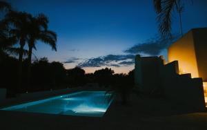 a view of a swimming pool at night at Dimora Santa Caterina in Polignano a Mare