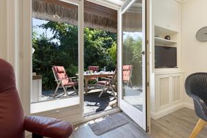 a living room with a sliding glass door leading to a patio at Fischers Koje in List