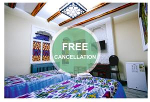 a room with two beds and a sign for free cancellation at BUKHARA HOUSE hotel in Bukhara