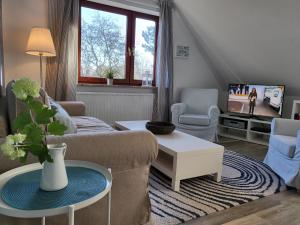 a living room with a couch and a table at Ferienwohnung 3 in der Waldstraße in Sankt Peter-Ording