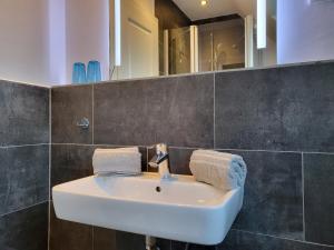 a bathroom sink with two towels on it at Ferienwohnung 4 in der Waldstraße in Sankt Peter-Ording +18 photos