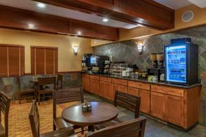 a restaurant with a table and chairs and a counter at Lloyd Hotel Astoria Bayfront, Ascend Hotel Collection in Astoria, Oregon