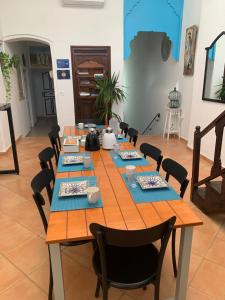 a long wooden table with chairs in a room at Dar Lola Djerba in Houmt Souk