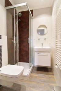 a bathroom with a shower and a toilet and a sink at Hamburg-App-05 in Ahlbeck