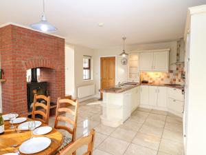 a kitchen and dining room with a table and a fireplace at Ballycahane in Castletownshend