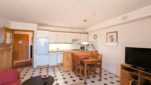 a kitchen with a table and a small kitchen with a tableablish at Ferienwohnung Eichhorn in Schwangau