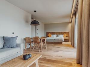 a living room with a couch and a table at Åhus Seaside in Åhus