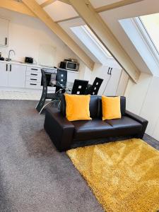 a black couch with yellow pillows in a living room at City Blessed Apartment 4 with free parking in North Shields