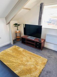 - un salon avec une télévision à écran plat et un tapis dans l'établissement City Blessed Apartment 4 with free parking, à North Shields