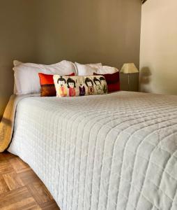 a bedroom with a large white bed with pillows at Casa Dash Beach Houses in Punta del Este +64 photos