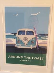 a poster of a car parked on the beach at 34 Surfview Beach House in Newquay