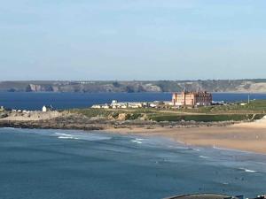 a view of a beach with a castle in the distance at 34 Surfview Beach House in Newquay