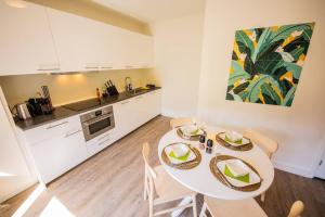 a kitchen and dining room with a table and chairs at Lovely 3 Bedroom Apartment in Eindhoven 65m2 in Eindhoven