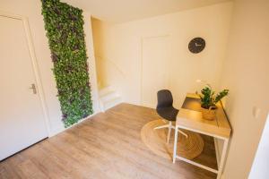 a room with a desk and a chair and a plant at Lovely 3 Bedroom Apartment in Eindhoven 65m2 - SD23N in Eindhoven