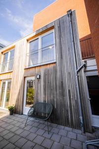 a chair sitting on a patio in front of a building at Lovely 3 Bedroom Apartment in Eindhoven 65m2 in Eindhoven