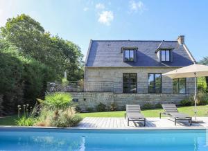 a house with a swimming pool in front of a house at Maison de la Vicomté in Dinard