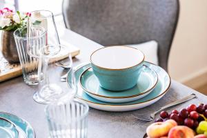 a table with a bowl and plates on a table at Villa 19 am Schloss Ranzow - Fräulein Ava in Lohme