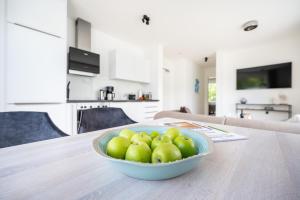 a bowl of green apples sitting on a table at Villa Zweite Heimat - Exklusive Penthouse No 4 in Lohme