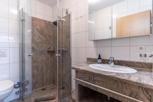 a bathroom with a shower and a sink and a toilet at Haus-Eriel-EG-rechts in Brösum +21 photos