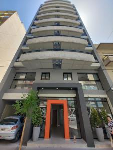 a tall building with an orange door in front of it at C&R APART in Mar del Plata