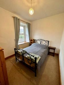 a bedroom with a bed and a window at Flatts farm, Yorkshire dales home in Skipton