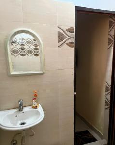 a bathroom with a sink and a mirror at Divine view - 1 bhk AC - Swarna Bhavan in Puri