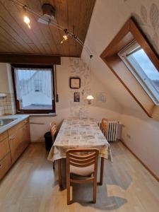 a kitchen with a table with chairs and a window at Hell und gemütlich, ca. 60qm. in Osnabrück