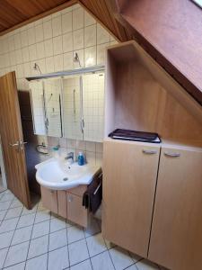 a bathroom with a sink and a mirror at Hell und gemütlich, ca. 60qm. in Osnabrück +16 photos