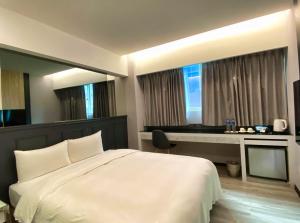 Postelja oz. postelje v sobi nastanitve Hub Hotel Ximen Inn