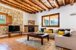 a living room with a couch and a table at Oasis Living Villa Can Ramon in Cala Llonga
