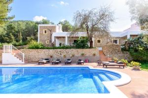 a villa with a swimming pool and a house at Oasis Living Villa Can Ramon in Cala Llonga