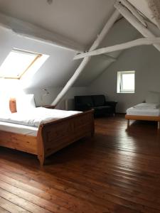 a bedroom with a bed and a couch in a attic at Kranenbruch in Schwalmtal