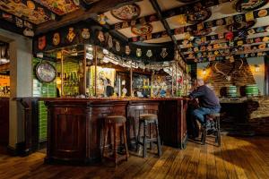 a man sitting at a bar in a pub at The Old Ship Aground in Minehead