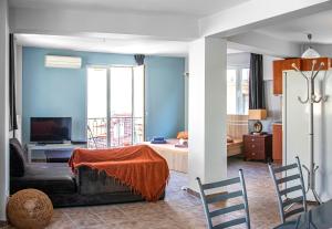 Loft في أثينا: غرفة معيشة مع أريكة وغرفة مع سرير