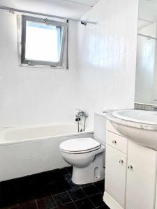 a white bathroom with a toilet and a sink at Estudio Frente al Mar en Roses con Vistas in Roses