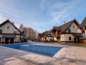 an image of a house with a swimming pool at Aparatament Mandala in Jaworki