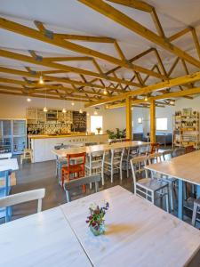 a restaurant with tables and chairs and a bar at Hostel Zahrada Mikulov in Mikulov