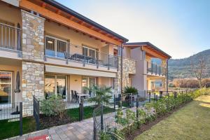an exterior view of a house with a fence at ApartmentsGarda - Garda31 Residence in Garda