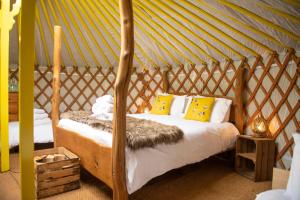 a bedroom with a bed in a yurt at Cherish Glamping in Askrigg