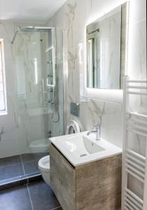 a bathroom with a sink and a shower and a toilet at Loft in Athens